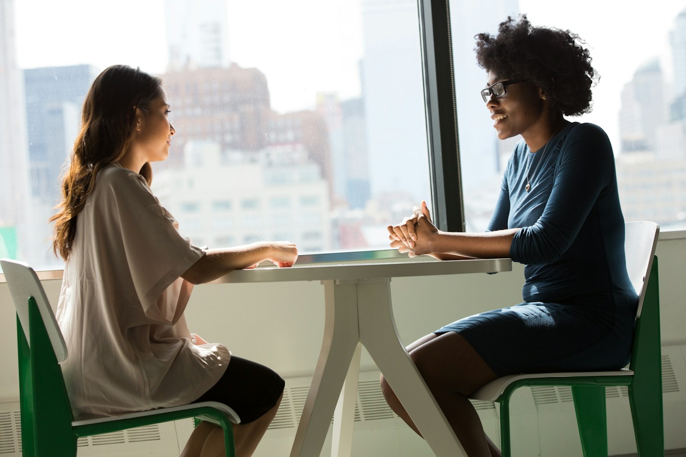 two women discussing a project with an Ark Quality team member